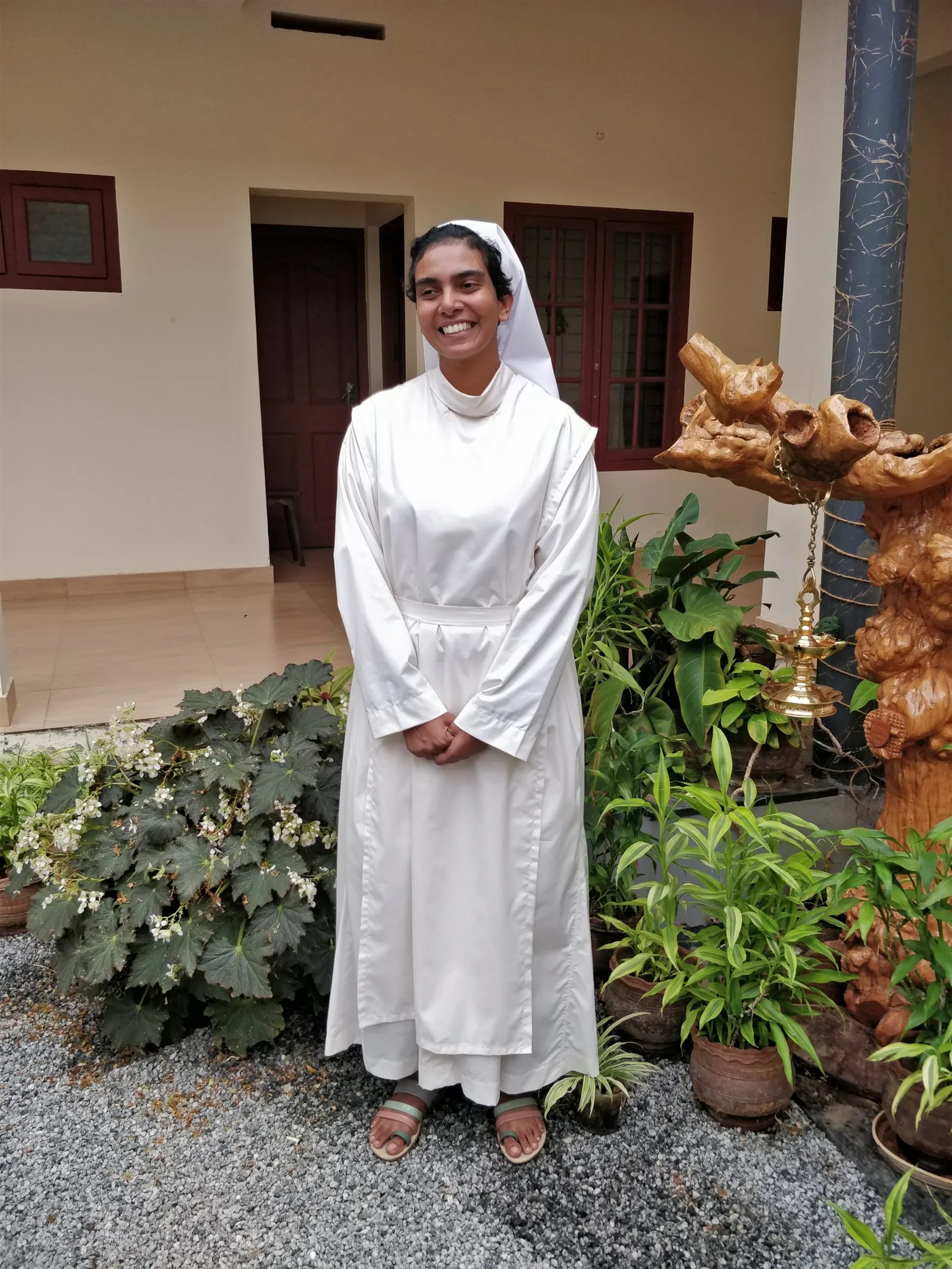A young sister wearing the white habit of formation