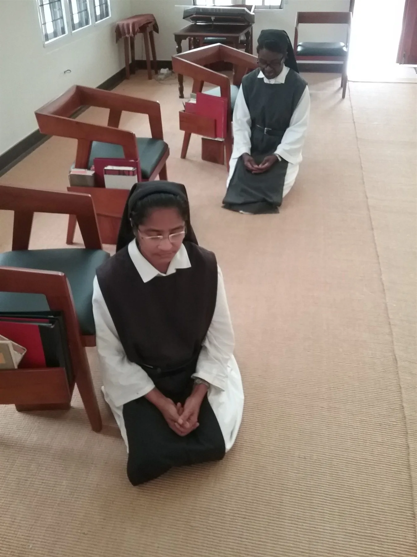 Two sisters praying quietly in the chapel